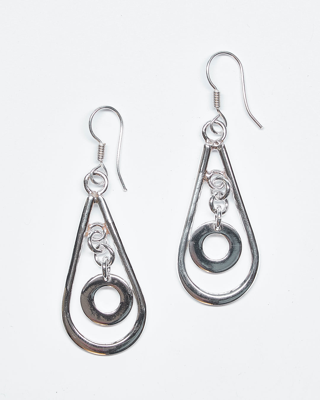 Elegant sterling silver teardrop earrings with a floating circle dangle by Renata Rubio 92.5 - Handmade sterling silver jewelry with a lifetime warranty.