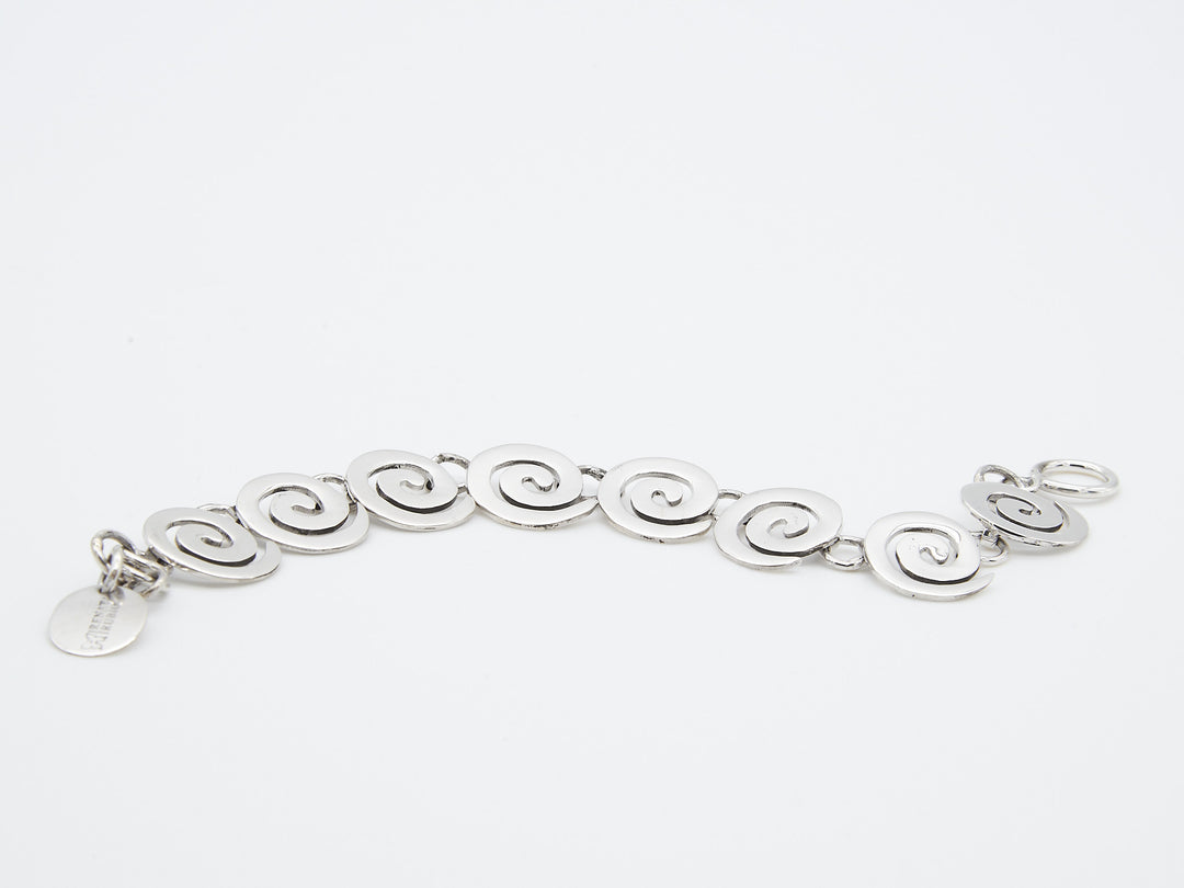 Coiled sterling silver bracelet by Renata Rubio 92.5 – handcrafted, high-polish silver with a secure T-toggle closure.