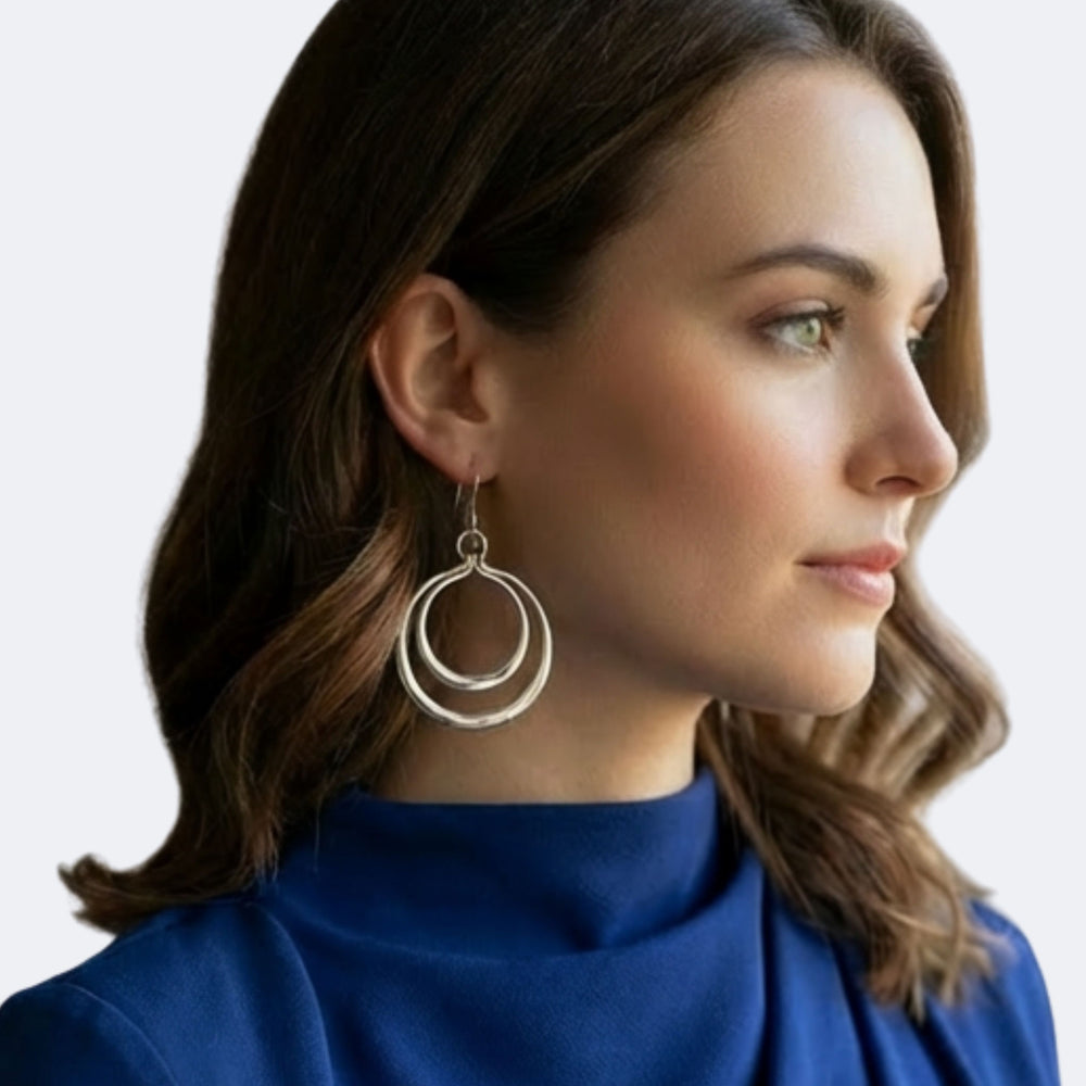 Women wearing double circle silver earrings by Renata Rubio 92.5 – handmade, high-polish, and elegantly designed artisan jewelry.  Handmade fine sterling silver jewelry with a lifetime warranty. 