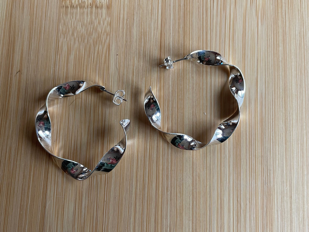 Twisted sterling silver hoop earrings with a classic, handcrafted design by Renata Rubio 92.5