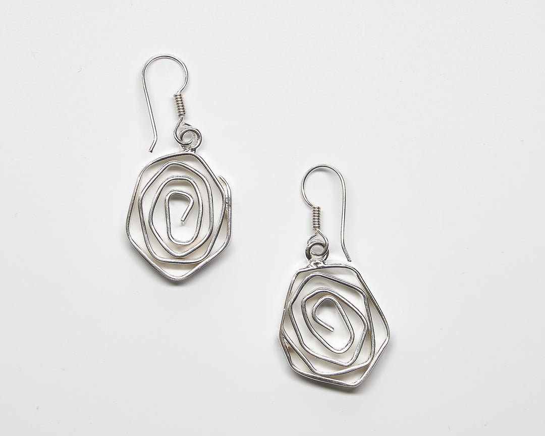 Labyrinth sterling silver dangle earrings by Renata Rubio 92.5 – handcrafted, intricate coiled wire design with a polished finish.