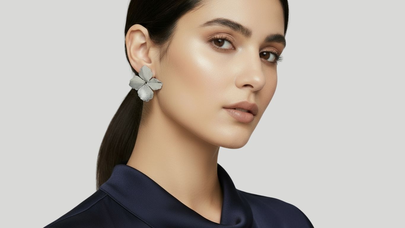 Woman wearing a floral Renata Rubio earring against a plain background.