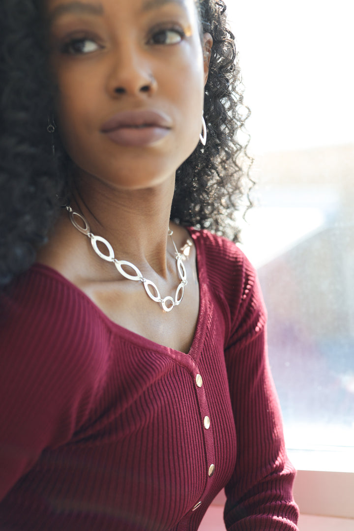 Seed-Shaped Silver Dangle Earrings on Model