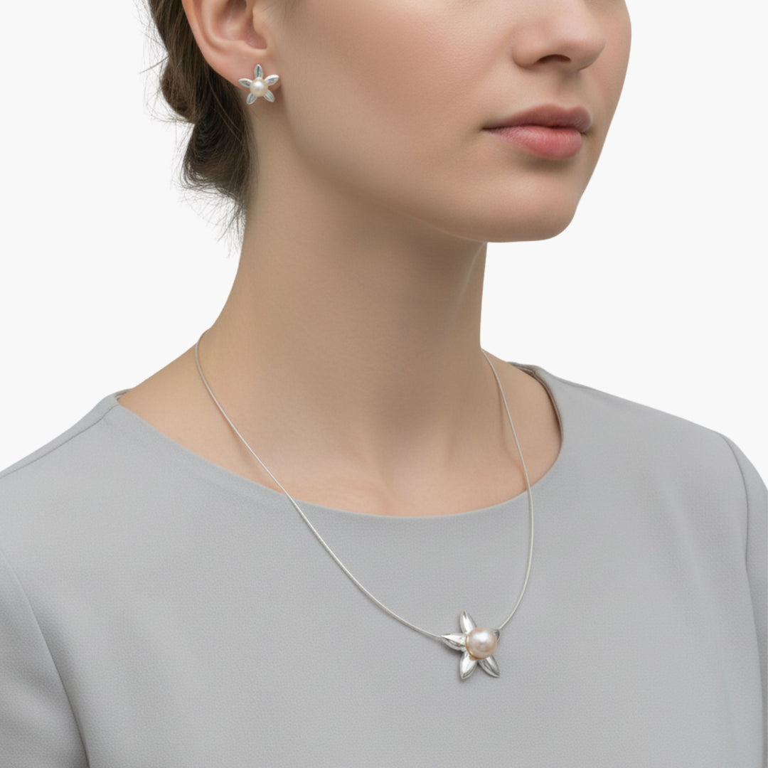 Women wearing Sterling Silver Blossom Pearl Earrings and Pendant Set by Renata Rubio 92.5, featuring high-shine floral design and matching pearls. Handmade fine sterling silver jewelry with a lifetime warranty. 