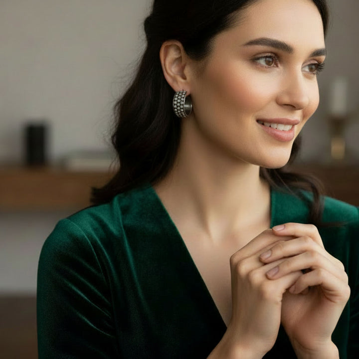 Woman wearing a green top with a blurred indoor background wearing Silver Hoop Earrings with Alternating Beads - Renata Rubio 92.5 - Handmade fine sterling silver jewelry with a lifetime warranty. 