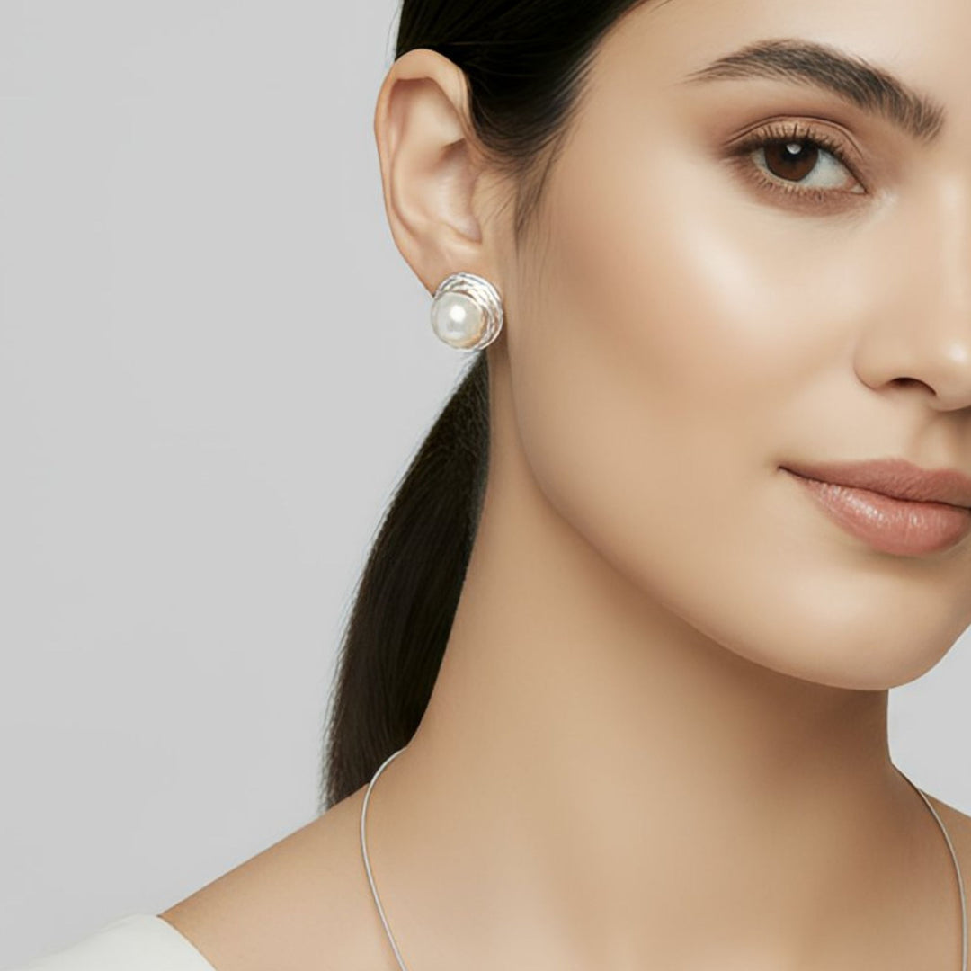 Woman wearing a pearl necklace and Sterling Silver Nest Button Pearl Earrings and Pendant, handmade elegantly designed artisan jewelry.  Renata Rubio 92.5 Handmade fine sterling silver jewelry with a lifetime warranty. 