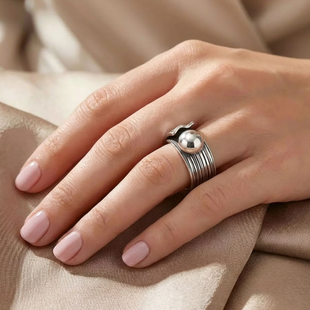 Lined sterling silver ring with center bead by Renata Rubio 92.5 featuring oxidized texture.